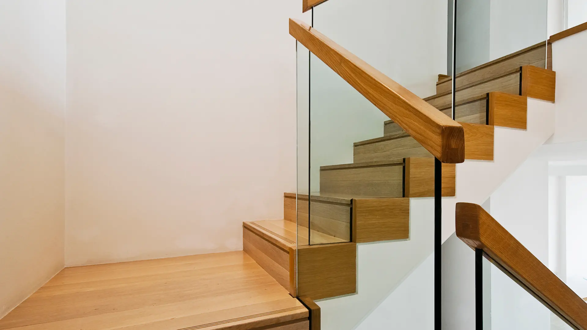 Wooden stairs with glass balustrade